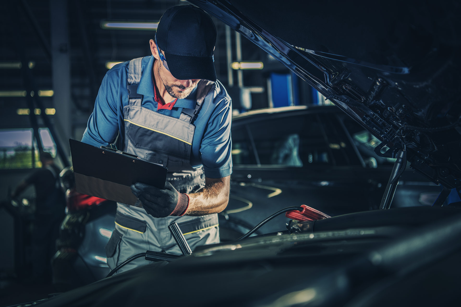 Mechanic checking off a vehicle during its MOT and Servicing Leighton Buzzard